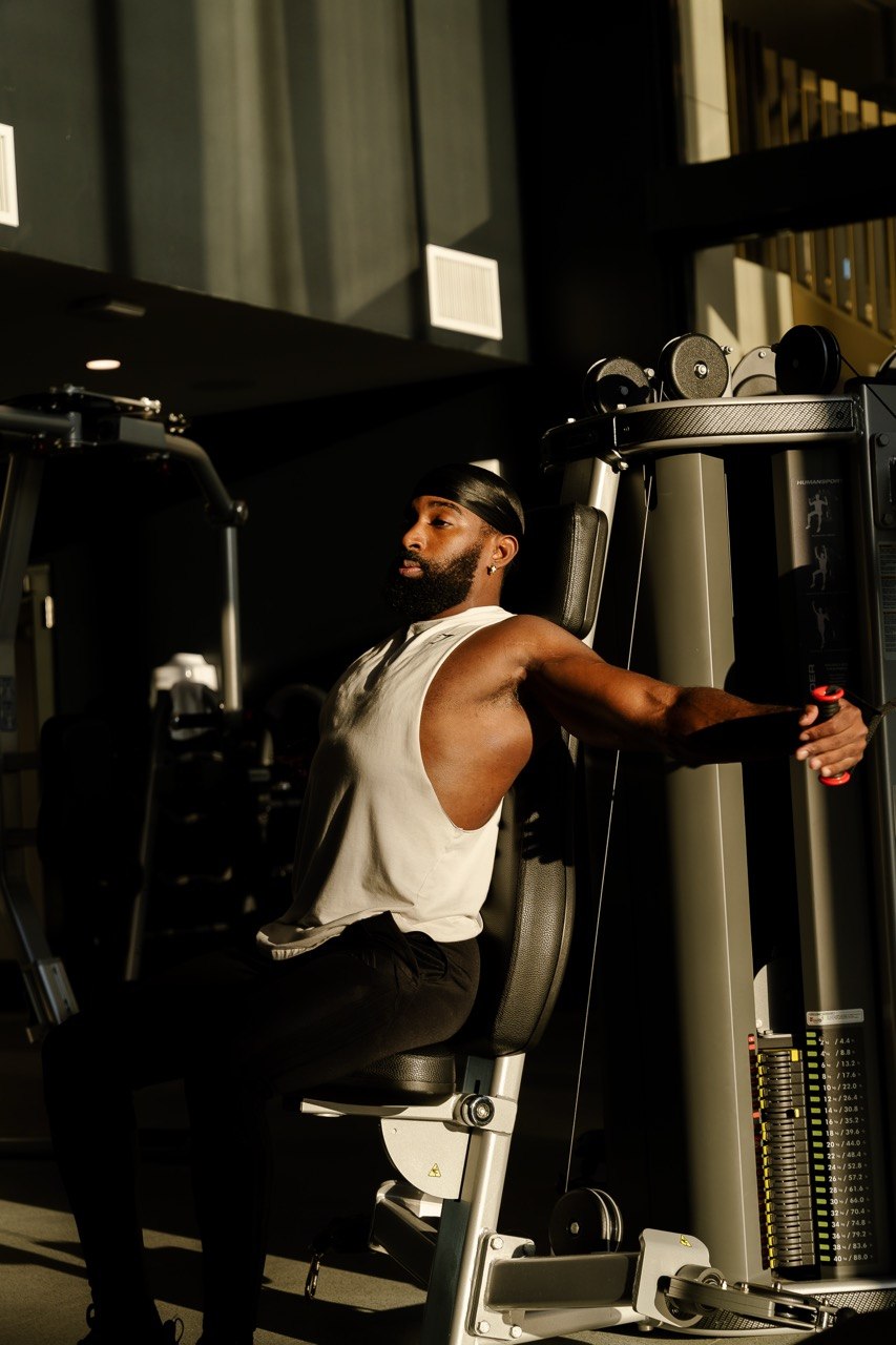 Sampson training on a chest fly machine for Day 6