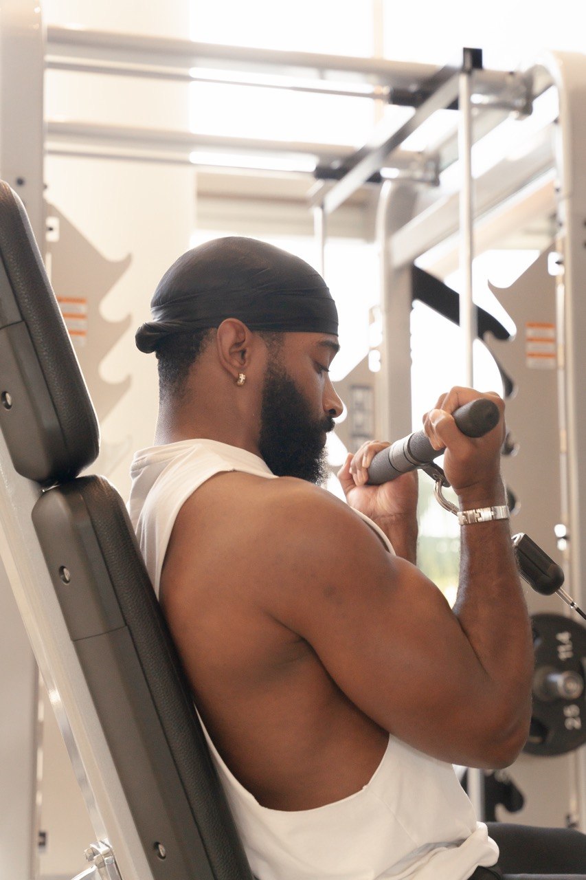 Sampson performing a seated cable curl for Day 3