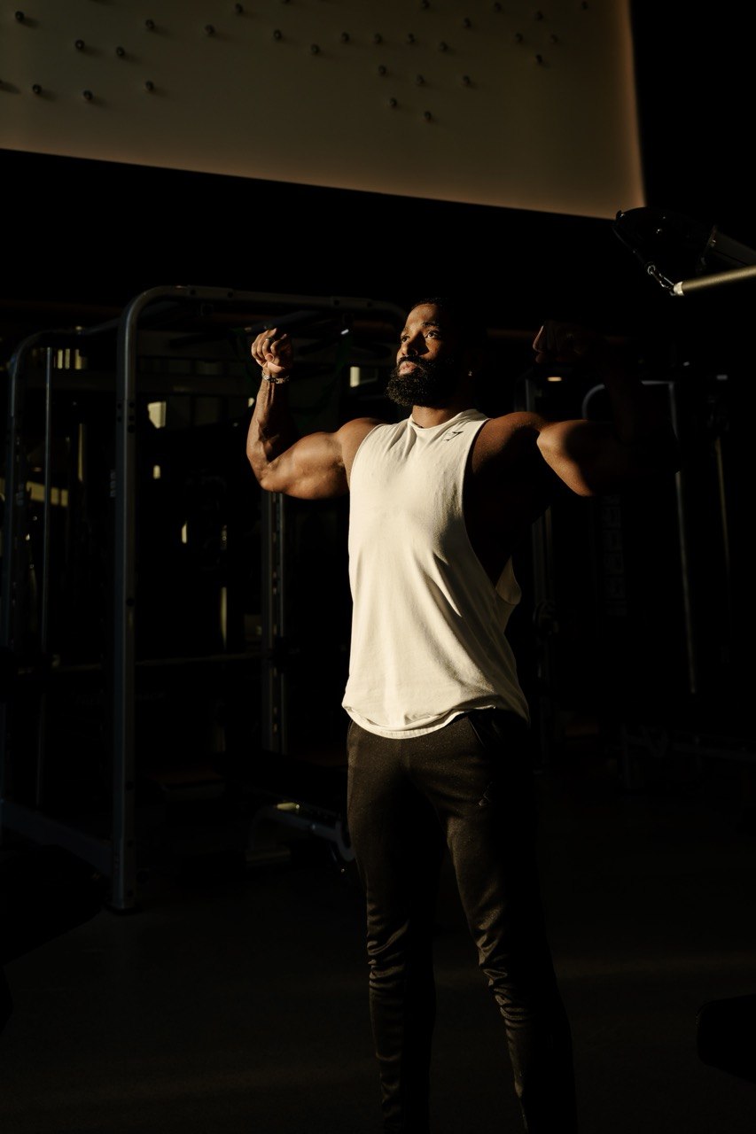 Full-body portrait of Sampson in dramatic gym lighting for Day 5